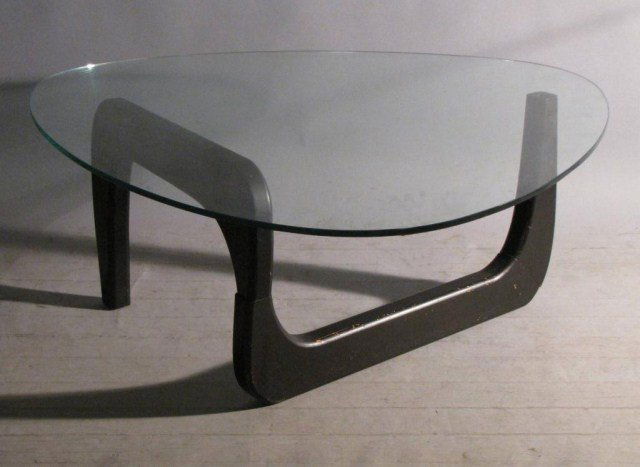 EBONY MODERN NAGUCHI GLASS TABLE: Glass and base show discernible wear, however table is most presentable despite any flaws, 39" X 40" X 16"H.