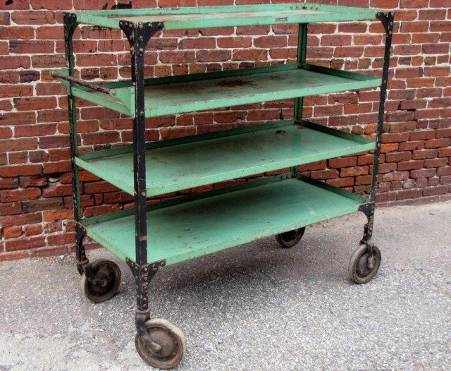 INDUSTRIAL JARVIS 4-TIER ROLLING RACK: Heavy bolted steel with handle and reinforced corners, probably from the 1920's - note the original manufacturer's tag. Obvious indications of use and natural wear (as shown), including paint loss and