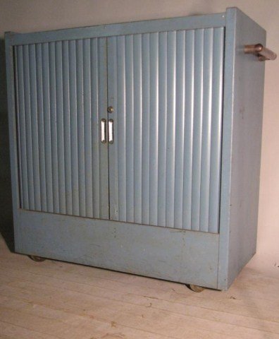 AMERICAN INDUSTRIAL BLUE TAMBOUR ROLLING CABINET: Steel tambour doors exemplify the utilitarian style and efficiency of such a piece. Fat, heavy acrylic handles on each side, smoothly rolling casters. No identification but a solid and presentable pie