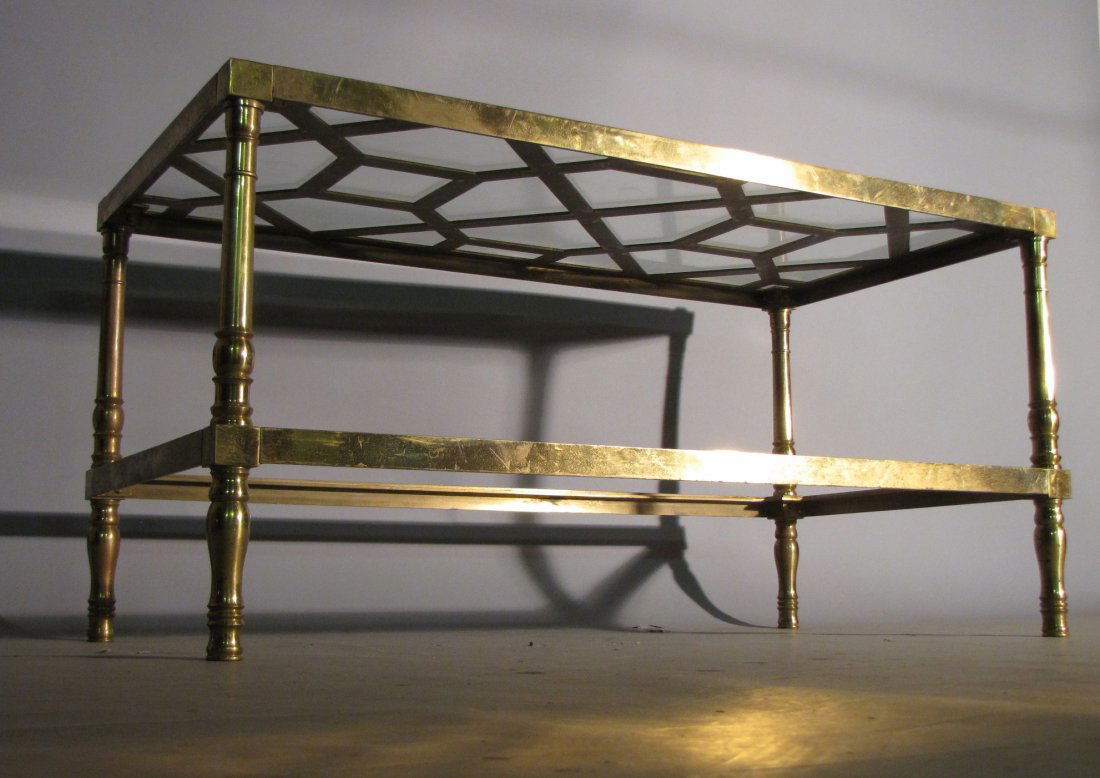 MAISON JANSEN STYLE BRASS COFFEE TABLE: Glass coffee table. Metal shows some spotting and tarnishing; lower glass shelf is missing. Otherwise, sound, sturdy and presentable, 20"H X 40"W X 20"D.