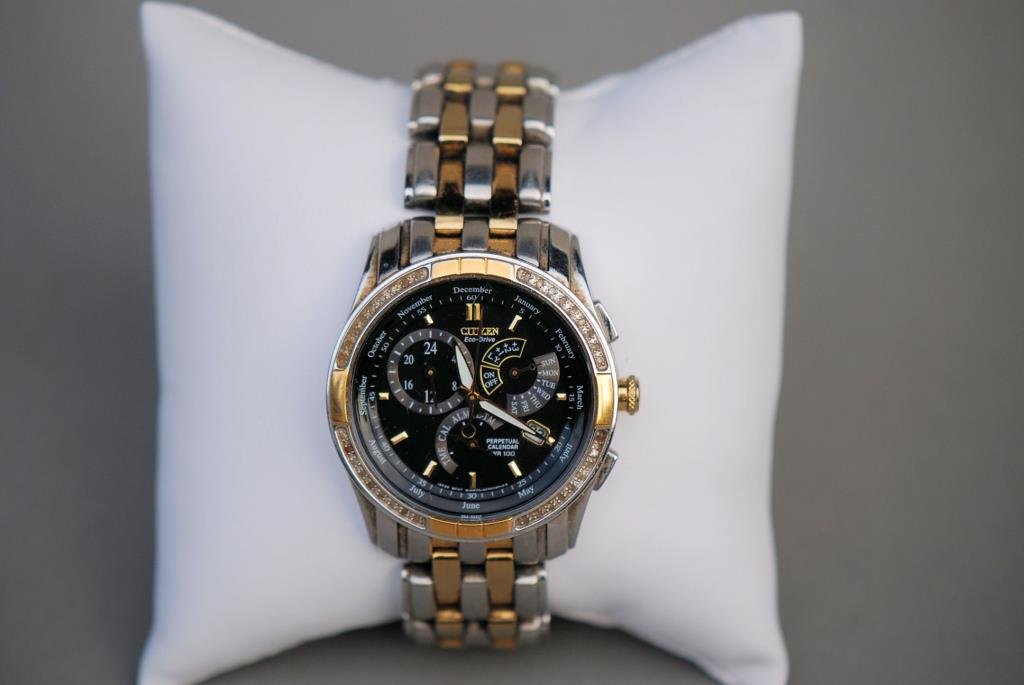 Citizen Eco Drive Man's Wristwatch: Citizen Eco Drive Man's Wristwatch. Two-tone stainless band, black face with multiple dials.