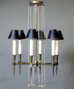 Tommi Parzinger 6 Arm Chandelier: Tommi Parzinger fine original brass chandelier with six candlestick fixtures topped by flaring cylindrical shades. The frame is draped with strands of glass beads, Circa 1950's. Removed from a Rittenh