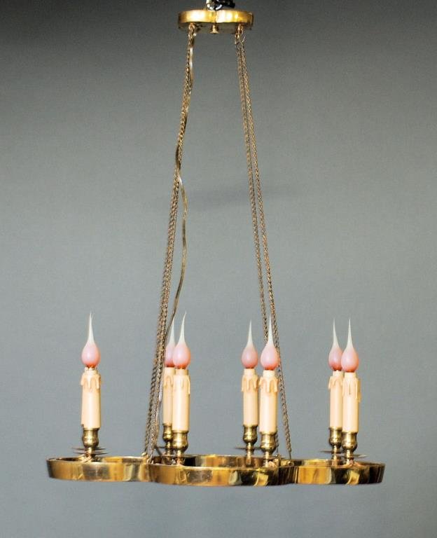 Tommi Parzinger Style Chandelier: Tommi Parzinger Style Chandelier. 8 Lights with brass frame and chains. Removed from a Rittenhouse Square apartment. 31"H X 22"W X 17"D. In good condition.