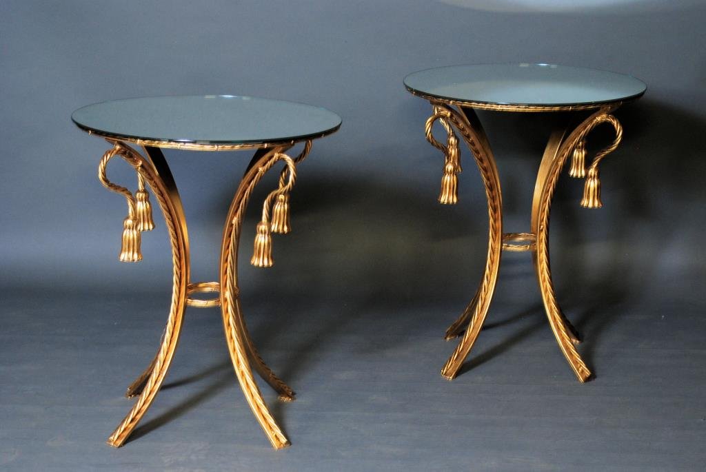 Napoleonic Style Mirrored Tables: Pair of Napoleonic Style Gilt Mirrored Top Tables. Gilt metal tassel form tables with mirrored tops. 28 1/2"H X 24" Diameter. In good condition.