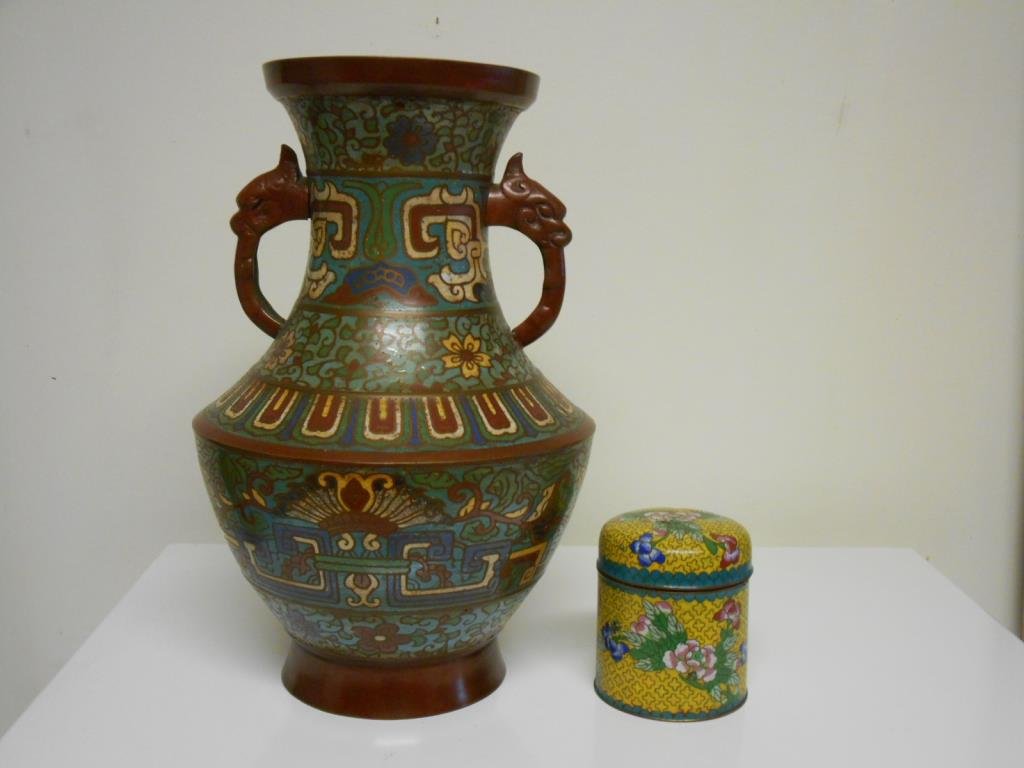 Champlevé Vase & Cloisonné Jar: Champlevé Vase & Cloisonné Jar Early 20th c. Japanese Champlevé & bronze 12" x 8" vase with animal head handles & an early 20th c. Cloisonné 9" x 8" cigarette jar. Condition: Vase is in very good
