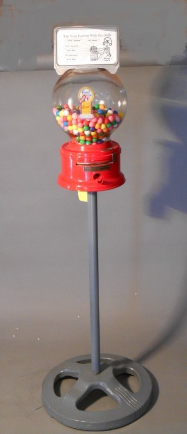 Ford Gumball Machine: Vintage 1950’s-1960’s Ford Gum and Machine Co. Inc 10 ¼” x 7” one cent gumball machine on original metal stand with key. Overall size is 42”.