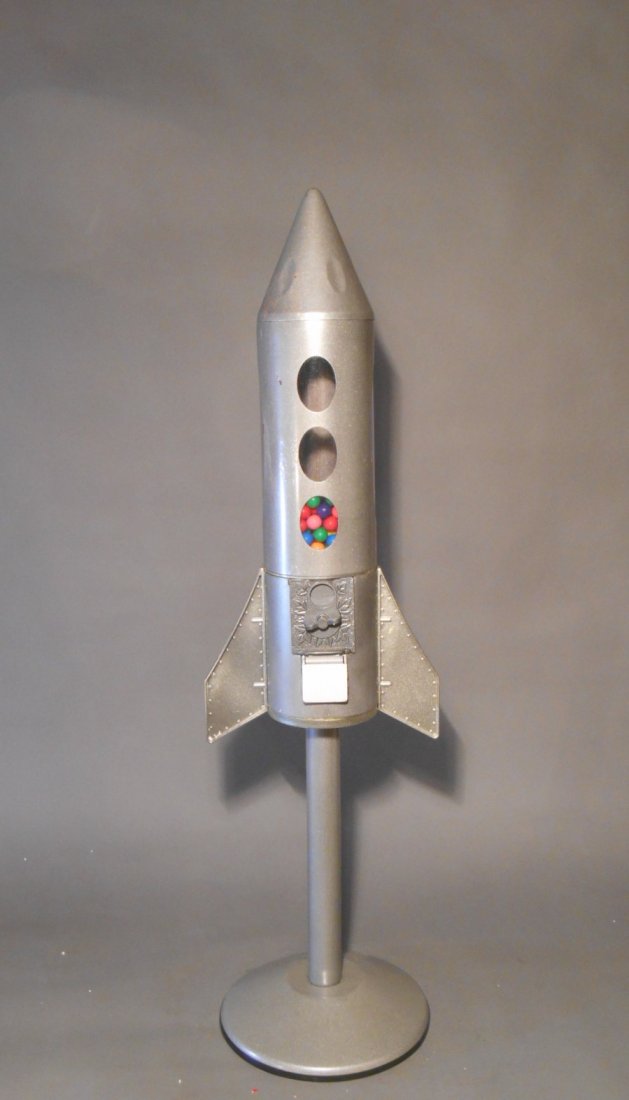Rocket Ship Gumball Machine: Vintage 1960’s plastic & metal rocket ship form 36” x 10” twenty-five cent gumball machine.