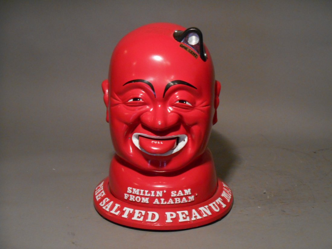 Smilin Sam Peanut Vendor: Reproduction Prince Mfg Co. Smilin’ Sam From Alabama The Salted Peanut Man 13 ½” x 9” x 10” one cent peanut vending machine with key.
