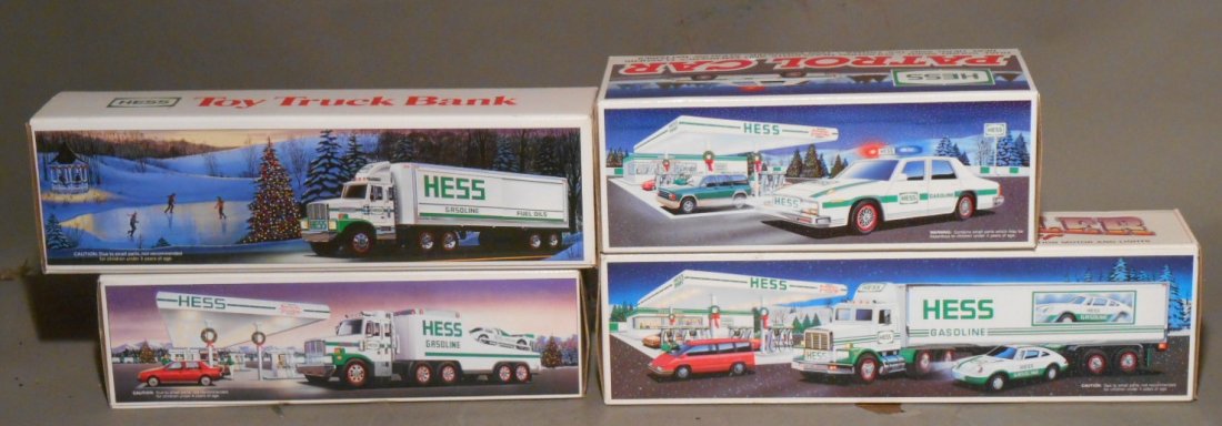 1980's & 1990's Hess Trucks: Lot of four 1980’s & 1990’s Hess trucks includes: 1987 Tractor w/Box Trailer, 1988 Race Car Transporter, 1992 18 Wheeler Box Truck with Racer & 1993 Patrol Car. All come with their original boxes.