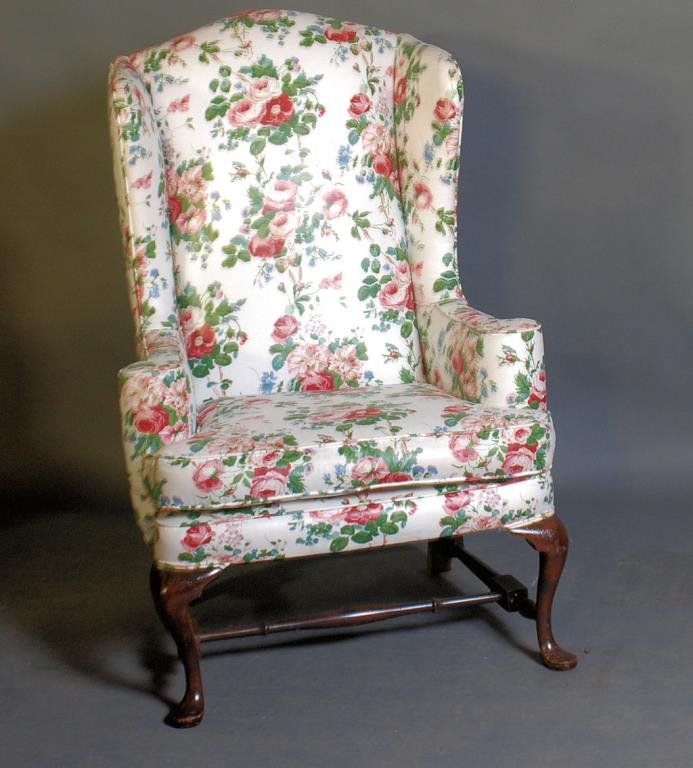 Queen Anne Style Wing Chair: Floral upholstery with down cushion. Possibly Kittinger. 46 1/2"H X 31"W X 33"D. In good condition.