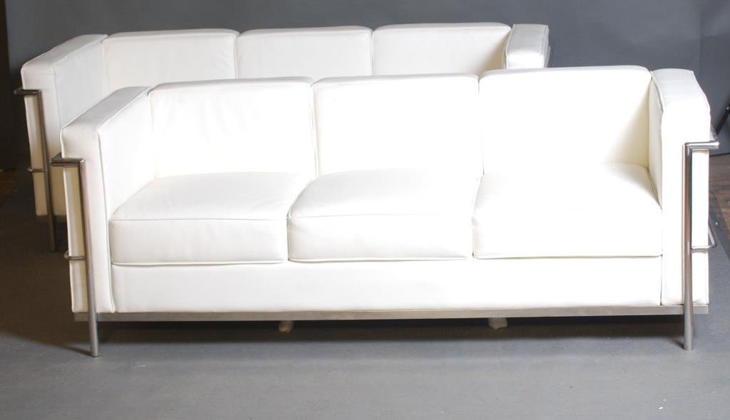 Pair of Le Corbusier Style White Sofas: 3 Seat white naugahyde E068 style sofas with chrome frames. 21 1/2"H X 71"W X 27"D. Minor wear - otherwise in good condition.