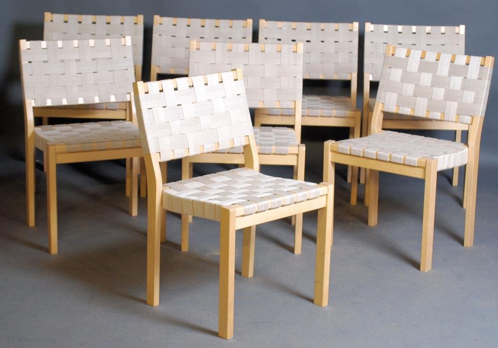 8 Alvar Aalto - Artek Dining Room Chairs: Maple frames with strap-webbed seats and backs.31 1/4"H X 19"W X 20"W. 2 chairs have chips on legs, and minor wear consistent with age - otherwise in good condition.
