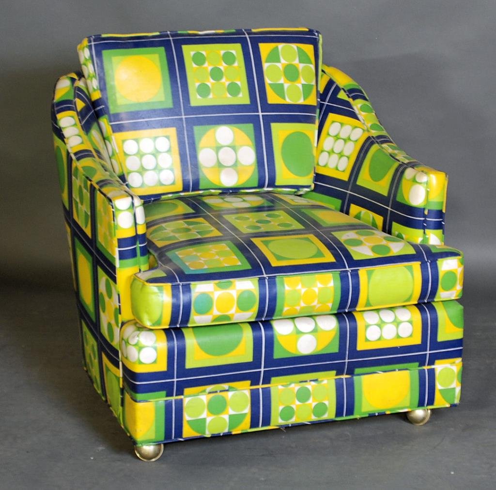 Funky 1960's Club Chair: Green, yellow, blue and white vinyl covered club chair on casters. 34"H X 32"W X 35 1/2"D. In good condition.