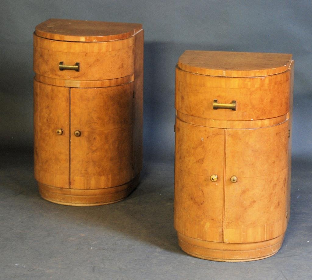 Pair of Gilbert Rohde End Tables: Demilune shape with burled walnut veneer. 25 1/2"H X 15 1/2"W X 14"D. Veneer and finish loss, loss to edge - otherwise in good condition.