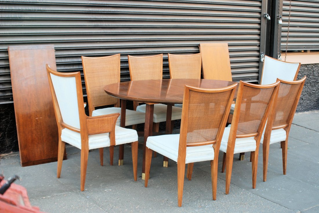 Michael Taylor for Baker Table & 8 Chairs: Two armchairs and 6 side chairs with caned backs along with a oval table that has 2 leaves. Minor rubs to the table finish and the chairs have discoloration to the fabric, otherwise in good condition.