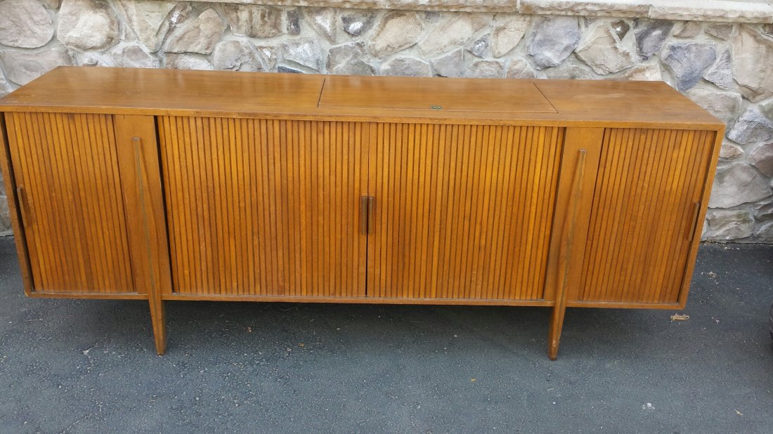 Mid Century Modern Bar Cabinet: American walnut veneer with tambour doors and lift top section lined with white formica.