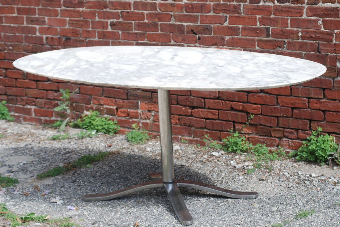 Knoll Style Marble Top Dining Table: Heavy chrome base with oval marble top. The top has rough edges - otherwise in good condition. 28 1/2"H X 70"W X 39 1/2"D.