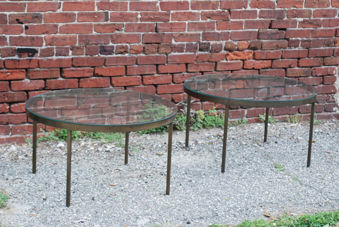Pair of Modern Design Tables: Heavy bronzed bases with round glass tops. Some oxidization to the bases - otherwise in good condition. 16 1/2"H X 30"Dia.