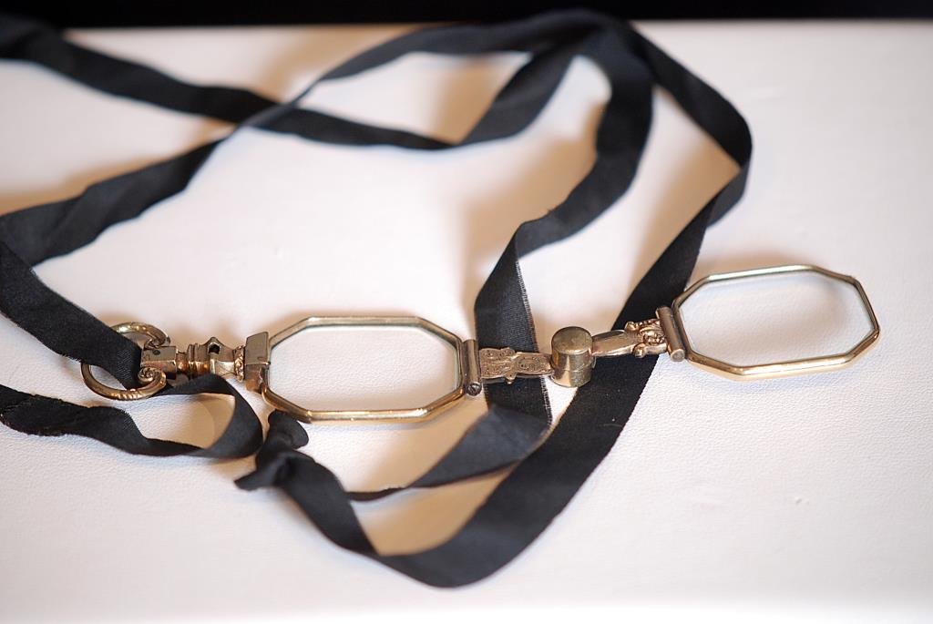 Pair of Mid to Late 19thC Lorgnette Glasses: Pair of mid to late 19th century gold filled framed Lorgnette Glasses with an attached black mourning ribbon. Condition: Very good with wear.