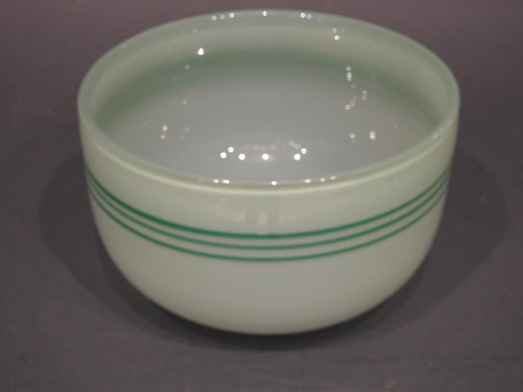 Orrefors Art Glass Bowl: Orrefors Art Glass Bowl, green with dark green triple lace band, artist signed "Gunner Cyren", 5 1/2"H X 8 3/4"D. Condition: Wear is consistent with age and use.