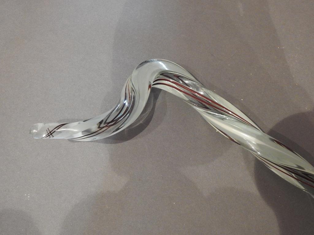 Antique Clear Glass & Design Parade Cane: Antique clear glass and maroon swirl design twist form parade Cane, 44"L. Condition: Very good with roughness at end top point.