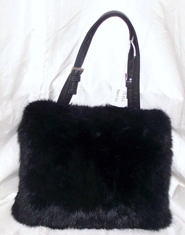 Fur Prada ladies purse: This purse measures 9 inches long by 7 inches wide without the handles. Marked prada, in great condition.