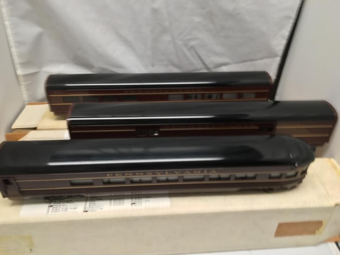 Phoenix Railways PRR O Gauge Streamlined Passenger Cars: Three (3) Phoenix Railways Pennsylvania O gauge streamlined passenger cars in the original boxes. Metal construction, each car is about 18” long. There is a baggage car, club lounge car, and an obse