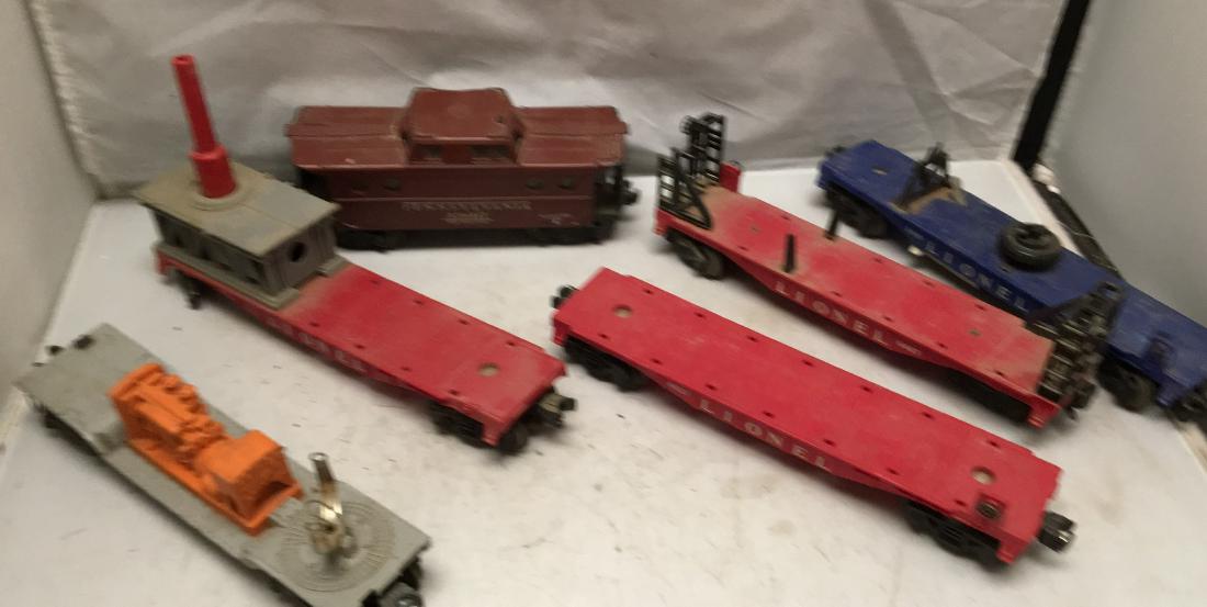 Lionel Postwar O Gauge Specialty Freight Cars: Six (6) Lionel Postwar O gauge specialty freight cars. There is a 6520 searchlight car (missing the searchlight), a missile launching car (missing some wheels, no missile), a 6821 flat car (no crates)