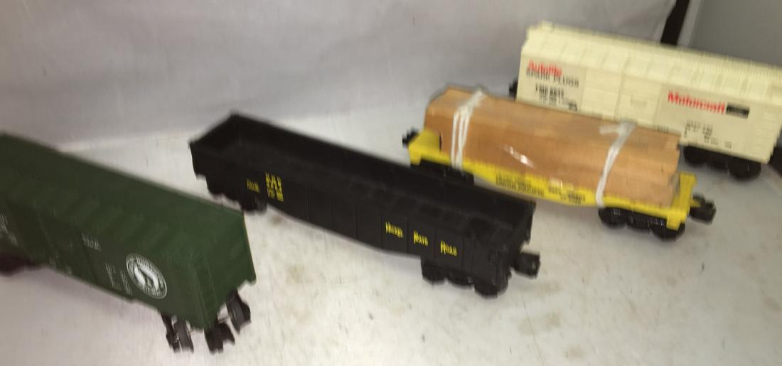 Lionel Modern Era O gauge Freight Cars: Four (4) Lionel Modern Era O gauge freight cars. There is a 9020 Union Pacific lumber car, a 9042 Ford Autolite box car, a 9339 Great Northern box car, and a 6254 Nickle Plate Road gondola car.
