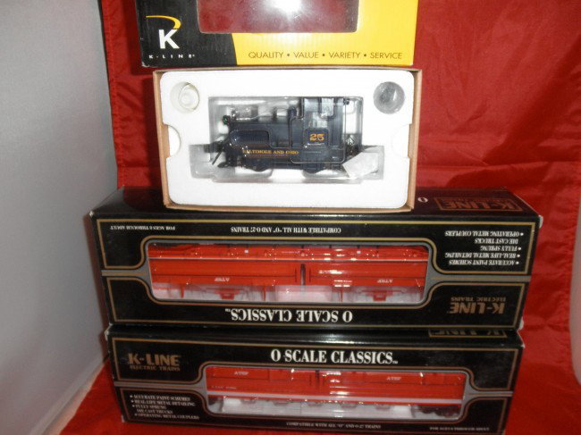 K-LINE O GAUGE DIESEL FREIGHT TRAIN OB: K-Line O gauge diesel freight train in the original boxes. Baltimore and Ohio smoking die cast diesel engine, 2 Santa Fe coil cars with coils.