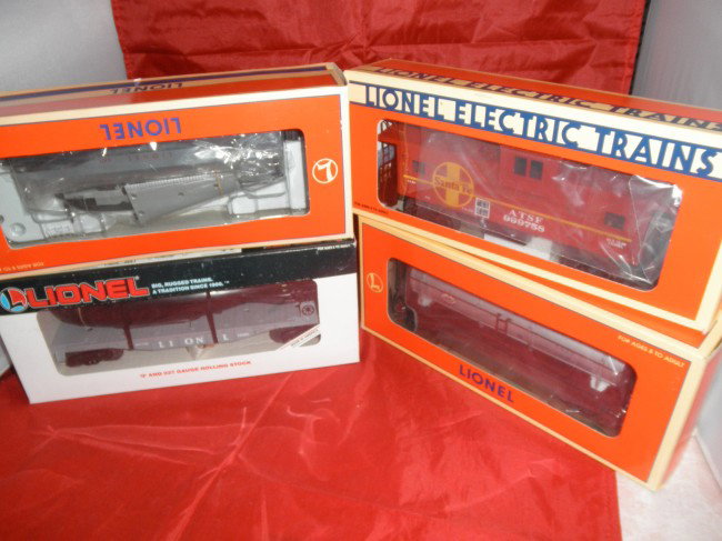 FOUR LIONEL O GAUGE FREIGHT CARS OB: Four (4) Lionel O gauge freight cars in the original boxes. #16187 Linex 3-dome tank car, #52102 Santa Fe Extended Vision caboose, #16351 Submarine car, #16969 Beechcraft airplane car.