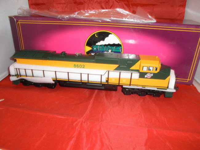 MTH PREMIER CNW O GAUGE DASH-9 DIESEL ENGINE OB: MTH Premier #20-2159-1 Chicago and Northwestern O gauge Dash-9 diesel engine with ProtSound in the original box.