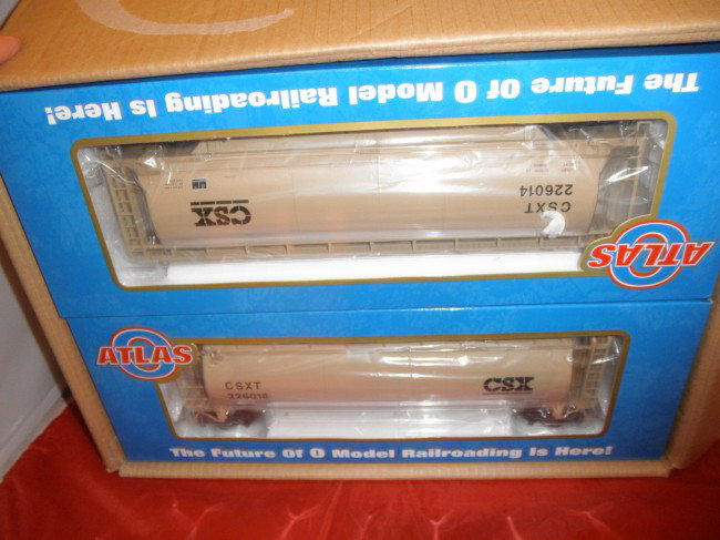 FOUR ATLAS CSX O GAUGE 3-BAY COVERED HOPPER CARS : Four (4) Atlas CSX O gauge 3-bay covered hopper cars in the original boxes and shipping box.