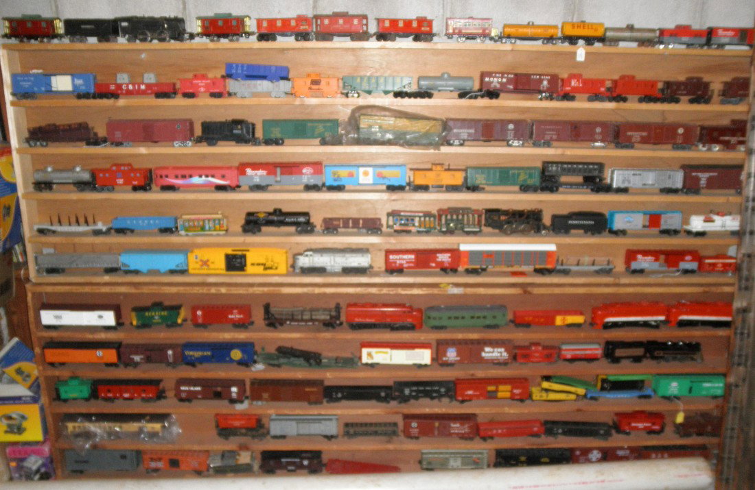 SHELF OF LIONEL O GAUGE TRAINS: Seventh from top shelf of Lionel Postwar and Modern O gauge trains. Three (3) Postwar Texas Special Alco diesels, Postwar green streamlined passenger car, freight cars.