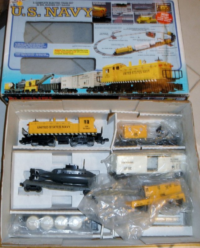 LIONEL 11745 US NAVY O GAUGE TRAIN SET OB: Lionel #11745 US Navy O gauge train set: powered and lighted NW type diesel engine (untested), Rapid Strike box car, gondola car with rocket fuel cannisters, operating crane car, submarine carrier car