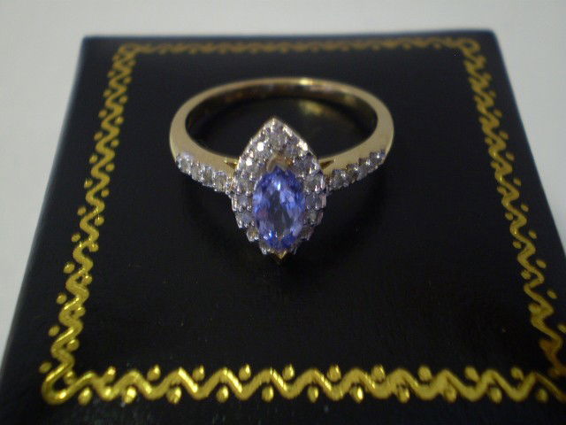 10k Gold and Amethyst Ring: Beautiful 10K Gold and Amethyst surrounded by Diamonds Ring, Size 6 1/4.