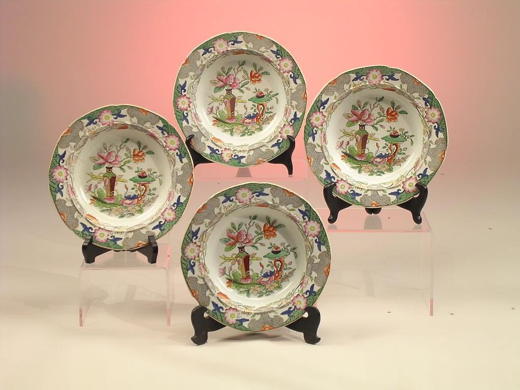 FOUR MASON'S PATENT IRONSTONE CHINA BREAD PLATES(1: in the Flower Pot and Table pattern, each decorated with a diapered border of stylized ruyi and flowers centering a vignette depicting a flower filled vase on a large leaf with swan on a rockwork tabl