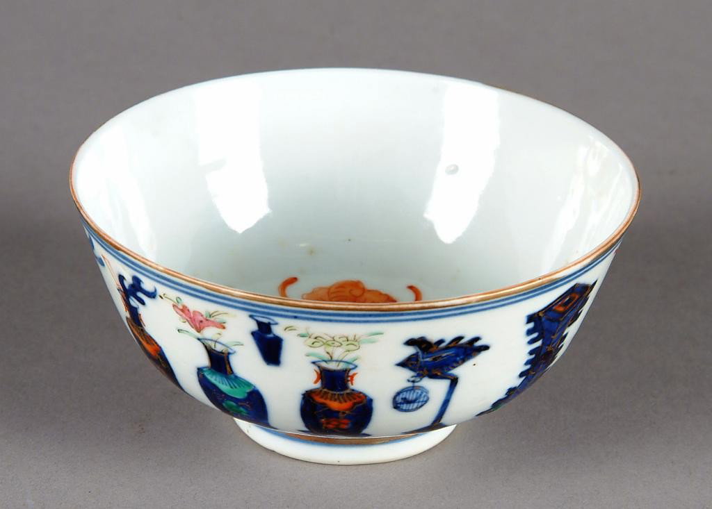 A CHINESE IMPERIAL BLUE AND WHITE BOWL,: POSSIBLY QING DYNASTY, GUANGXU PERIOD, enameled with auspicious vases enclosing an interior with longevity symbol, surrounded by five iron red bats, with gilt highlights throughout. Six character mark