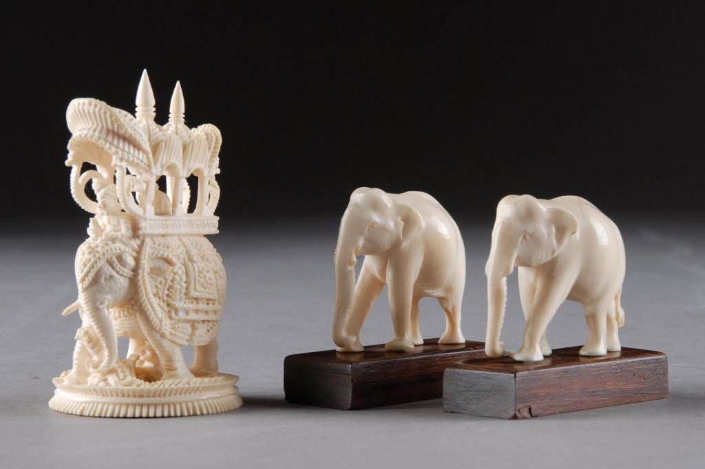 A GROUP OF VINTAGE MINIATURE IVORY ELEPHANTS: POSSIBLY INDIAN, THIRD QUARTER 20TH CENTURY, comprising a pair of sensitively detailed elephants with characteristic incised down scrolled trunks, face, and body, lacking tusks, on hardwood stands, he