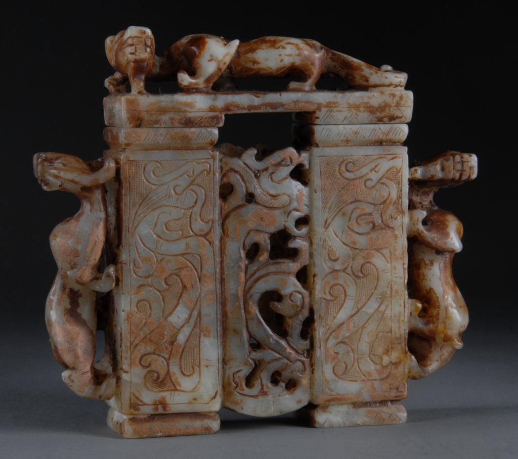 A CHINESE CARVED JADE ARCHAISTIC STYLE VASE: DOUBLE LIDDED VASE, 20TH CENTURY, with pawed rectangular vasi form body centering stylized- bud form panels in shallow relief flanking reticulated panel enclosed by qilon figural handles and surmounte