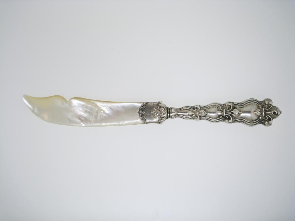 A VICTORIAN ERA LETTER OPENER STERLING WITH MOTHER: OF PEARL, 6 ½ " in length Victorian era letter opener features a sterling handle, stamped sterling with an encircled 'W' and also 'Pat.' stunning Mother of Pearl blade.