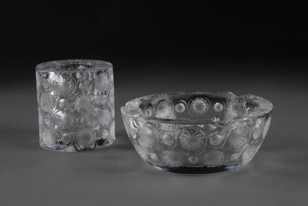 A LALIQUE TOKYO PART SMOKING SET ENGRAVED LALIQUE: France, late 20th Century Comprising; a cigarette holder, height: 3 1/8, diameter: 2 7/8, together with an ashtray, height: 2, diameter: 5 1/4.
