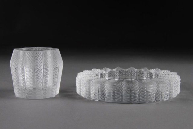 A LALIQUE LAMAIQUE PART SMOKING SET, ENGRAVED: Lalique France", late 20th Century. Comprising; a cigarette holder, height: 2 3/8", diameter: 2 5/8", together with an ashtray, height: 1 1/8", diameter: 5 3/8"."