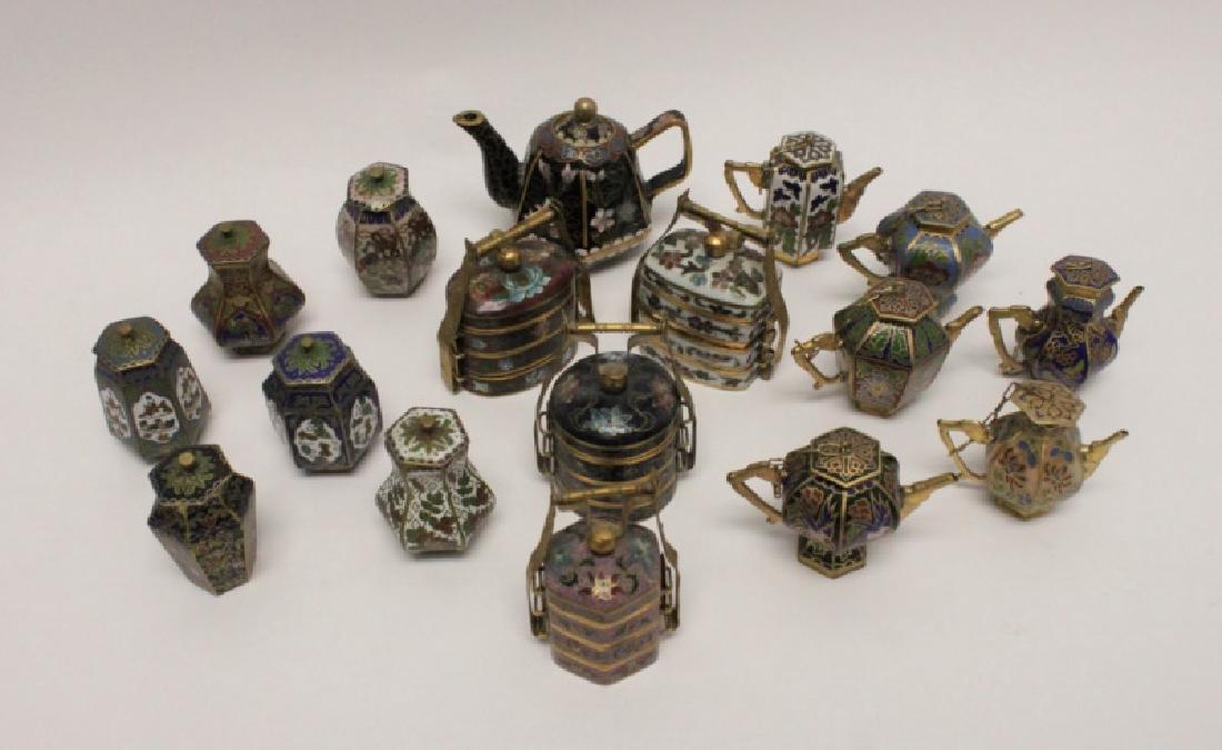 (17) Miniature Cloisonne Urns, Pitchers & Caddies: (17) Miniature Chinese Cloisonne lidded pill boxes or caches includes (7) "tea pots", (6) "urns, and (4) tiered "lunch or wedding boxes". Excellent condition. Largest "tea pot" measures 3" x 2" x 2.5"