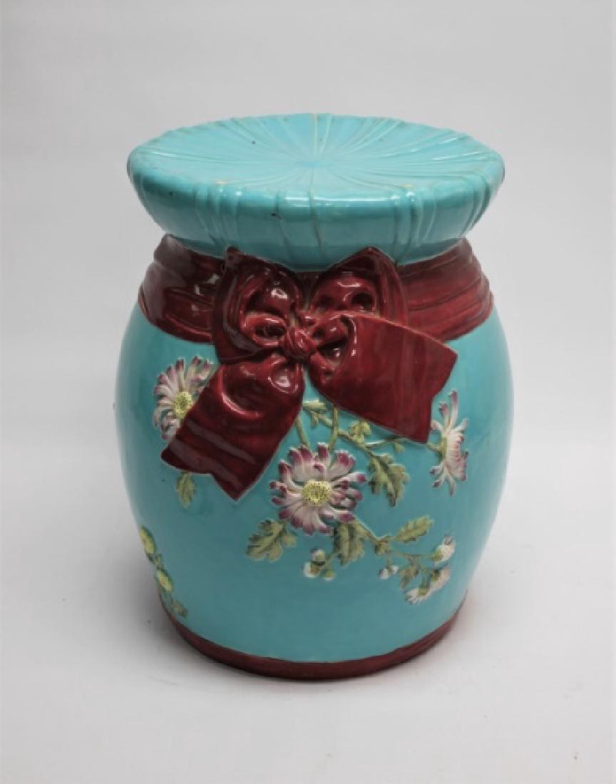 1890s Victorian Minton Majolica Floral Garden Seat: Victorian Minton Majolica garden seat with raised bow tie, floral blossom and pin-tucked cushion-form top. Marked with Minton stamp, registration lozenge, numbered and cipher dated 1894. Excellent ant