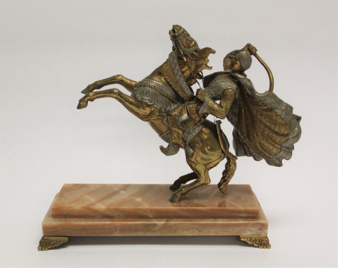 Antique Bronze Arabian Warrior on Horseback: Antique bronze Arabian warrior on horseback. Arab and horse both ornately dressed with nickel plated contrasting details. Warrior sits (hinged) atop his rearing horse, wielding his sword, with his clo