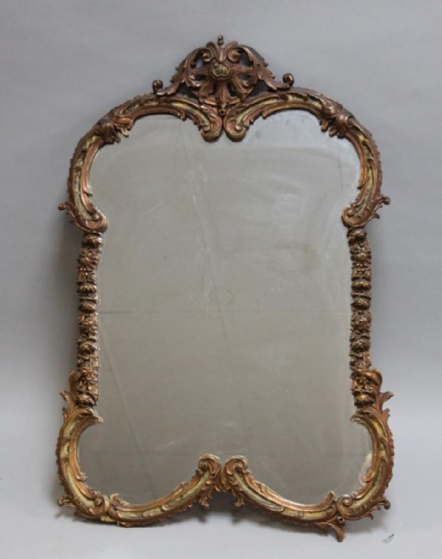 1940s Louis XV Ornate Wood & Gilt Gesso Mirror: 1940's Louis XV style ornate wood and gesso mirror with a gold gilt and painted finish. Very good antique condition (small loss to lower left frame, see photos). Measures 26.5" x 38".