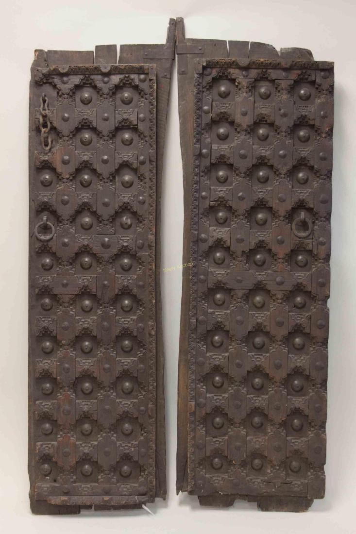 2 19c Moroccan Architectural Saloon Doors Shutters: Pair of 18/19th century Moroccan architectural saloon doors or window shutters. Heavy wrought iron bound primitive plank and limb reinforced panels. Excellent condition. Measure 20" x 3.5" x 64", each