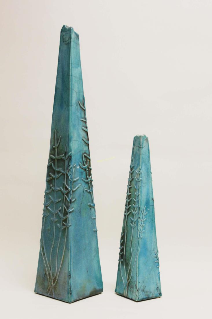 (2) Raku Pottery Turquoise Glazed Archaic Obelisk: (2) 1980's Raku Pottery archaic form obelisk, signed "Bob Huim" (?). Surfaces are embellished with rustic weed / fern patterns and finished with a turquoise tin glaze. Excellent condition. Measure 5.5
