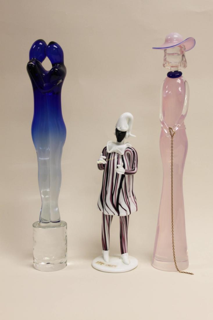 3 Murano Art Glass Figures Oggetti Tosi & Raffaeli: (3) Murano Art Glass Figures include: (1) Blue sculpture of two lovers, signed, "Giuliano Tosi" (excellent condition; measures 2.75" dia x 16.5"), (1) Sculpture of a woman wearing a hat, signed, "Elio
